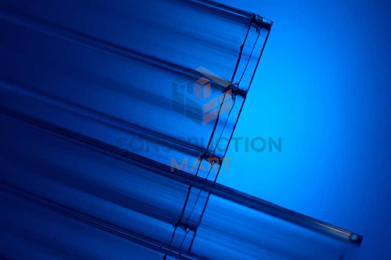Clear 16mm triple wall polycarbonate sheet photographed on blue background for material presentation