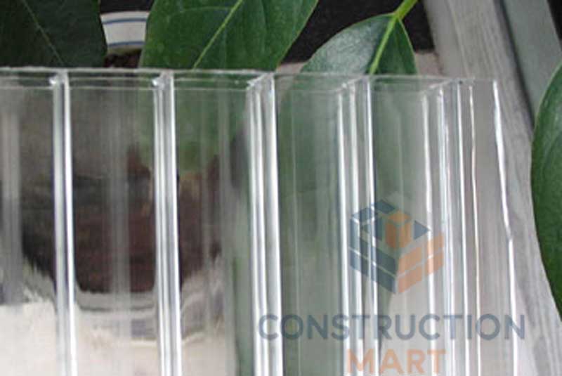 Functional anti-fog polycarbonate sheet with internal anti-drip coating, photographed with plants in the background, ideal for greenhouse roofing