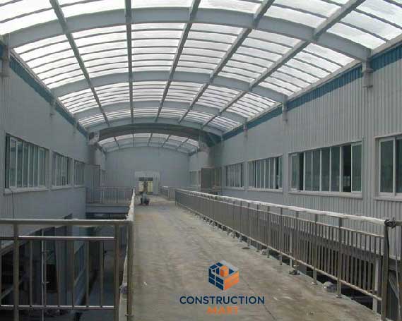 Industrial warehouse roofing system using Constructionmart 840 polycarbonate corrugated sheets, providing daylighting and weather resistance for factory buildings.