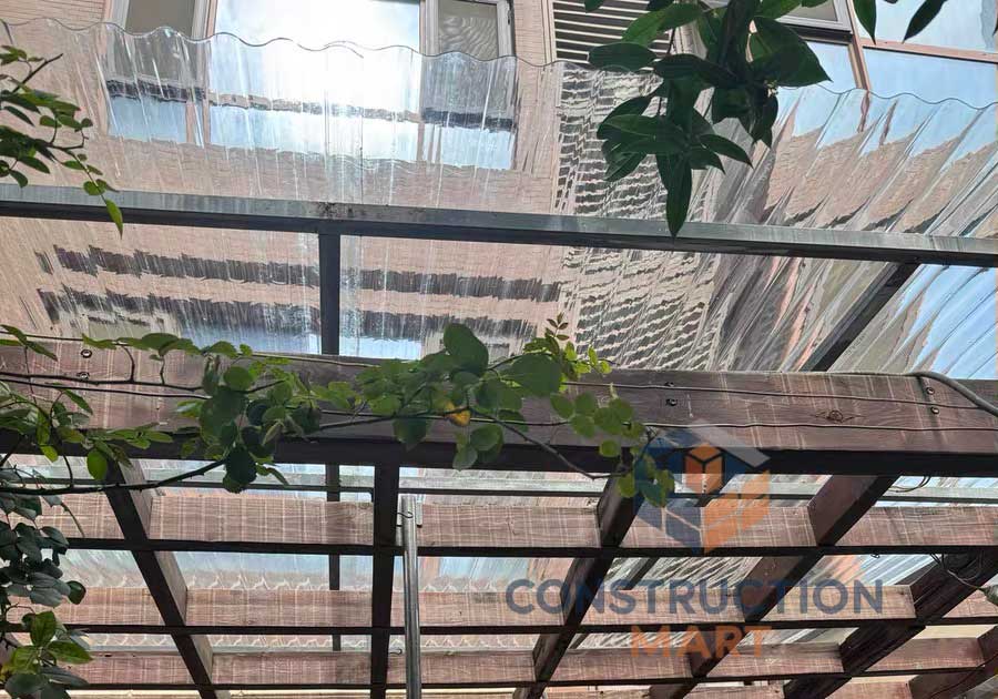 Transparent round corrugated polycarbonate sheet from Constructionmart used as a roof for architectural wave filter applications, photographed from below.