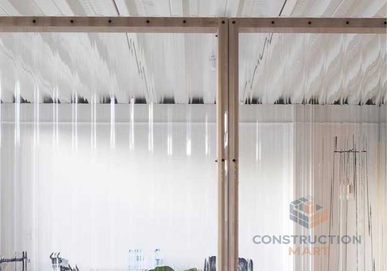 Round corrugated polycarbonate sheet from Constructionmart used as a decorative partition in garden landscape structures, combining aesthetics and functionality.