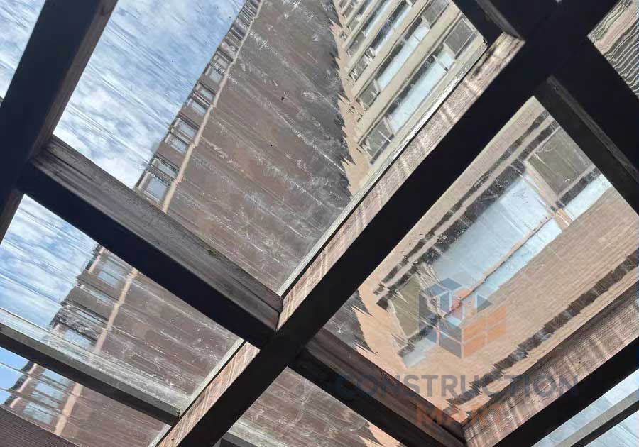 Round corrugated polycarbonate sheets by Constructionmart applied as roofing for modern commercial buildings, providing daylight and weather protection.