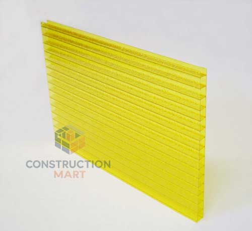 Bright yellow crystal polycarbonate sheet from Constructionmart displayed on the floor, showcasing its glossy and vibrant color.