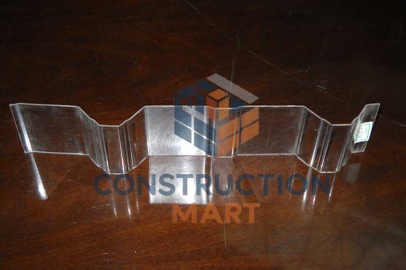A sample of wavy corrugated polycarbonate sheet placed on a table, demonstrating its flexibility and outdoor roofing application