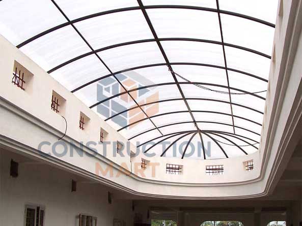 Modern office building entrance covered with polycarbonate canopy, providing shelter and architectural enhancement