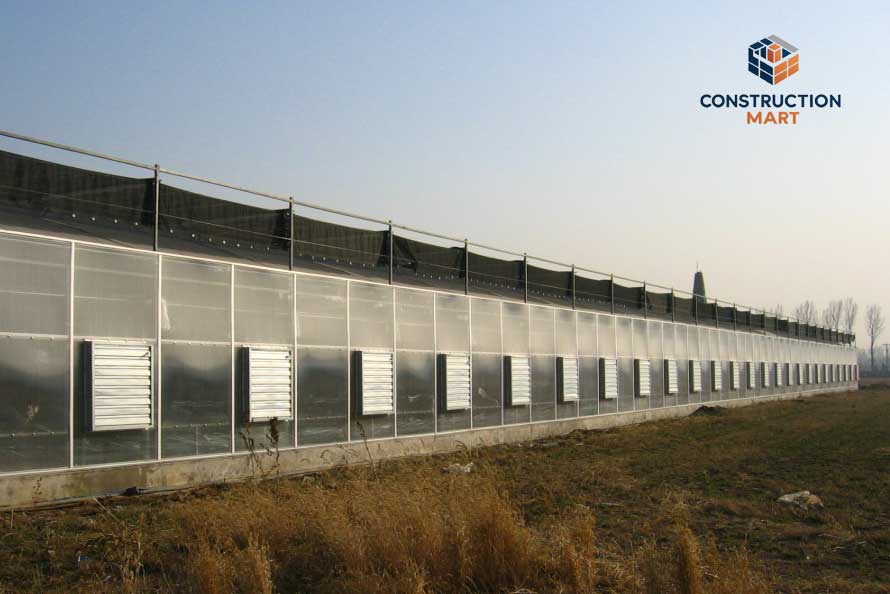 Interior view of a greenhouse project showing rows of transparent polycarbonate roofing panels