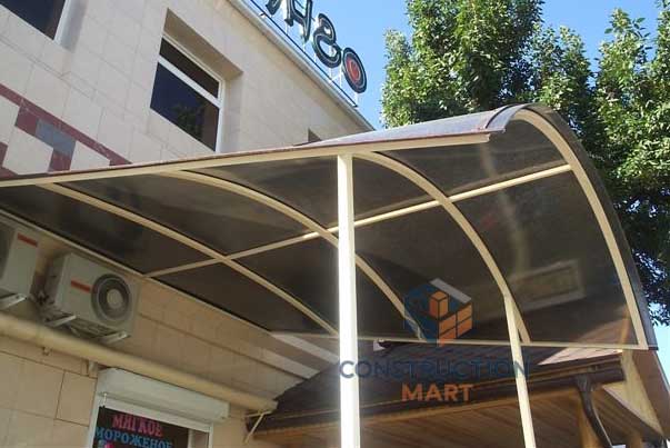 Compact entrance canopy using brown hollow polycarbonate sheet, designed by Constructionmart
