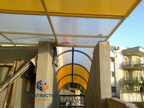 Commercial atrium roof using transparent and orange X-type polycarbonate panels for modern daylight architecture