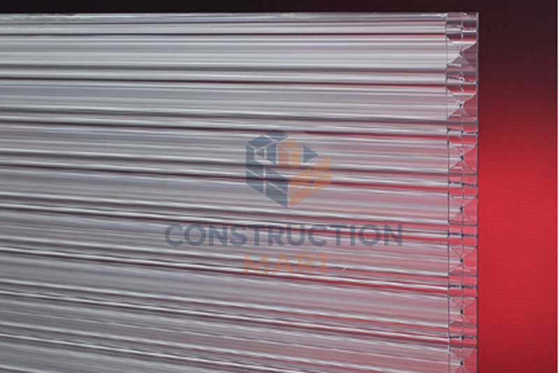 Transparent X-shaped polycarbonate sheet photographed on a red background, showcasing its high strength and multi-directional support structure