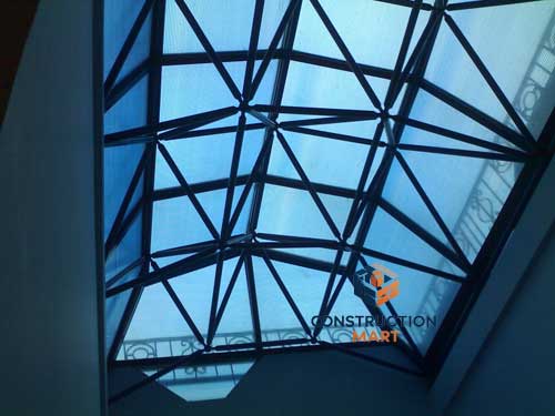 Interior view of warehouse roof using blue X-type polycarbonate skylight panels providing natural light and shading